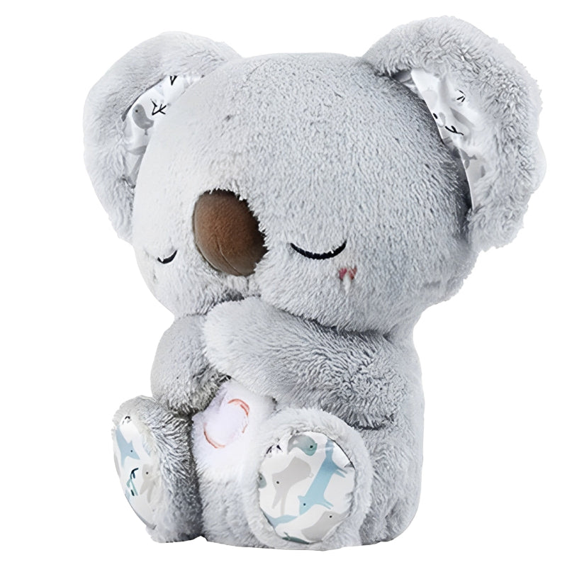 Gray plush koala toy with closed eyes on a white background