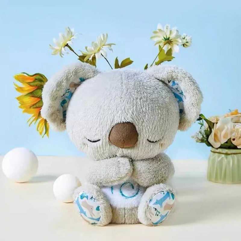 Plush koala toy with flowers on a light blue background